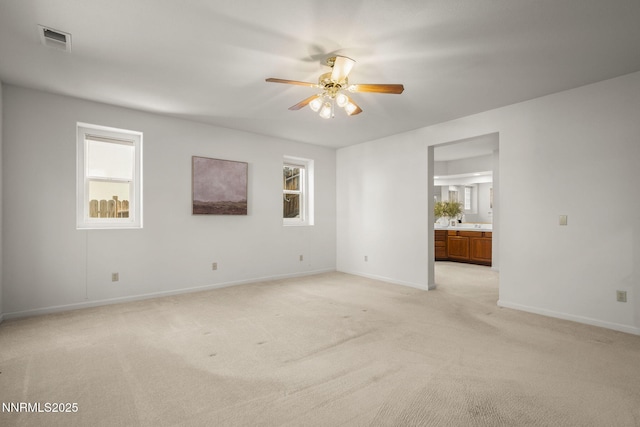 4811 Elkcreek Trl, Reno, NV 89519 - empty room featuring ceiling fan, light carpet, and healthy amount of natural light