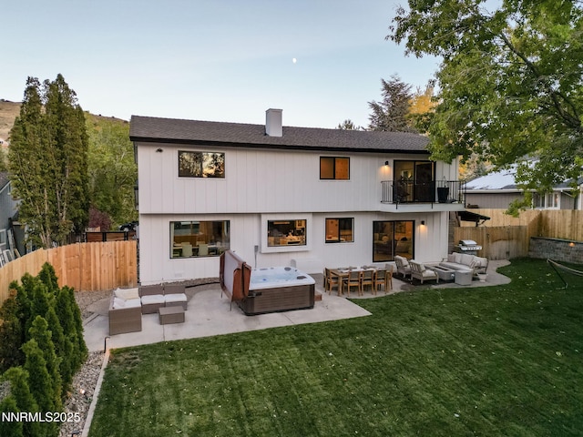 3390 Thornhill Dr, Reno, NV 89509 - back of property featuring an outdoor hangout area, a balcony, a patio, and a fenced backyard