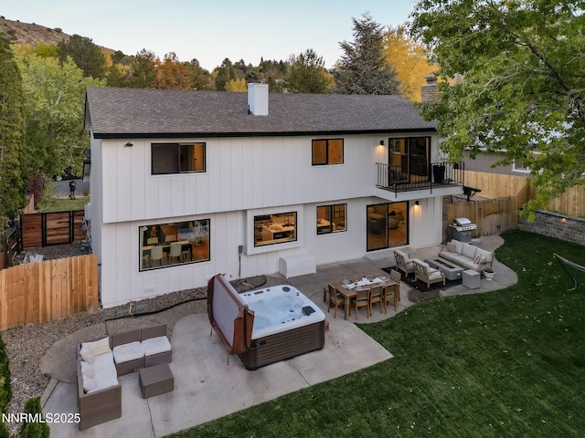 3390 Thornhill Dr, Reno, NV 89509 - rear view of house with an outdoor living space, a chimney, a balcony, a patio area, and a fenced backyard