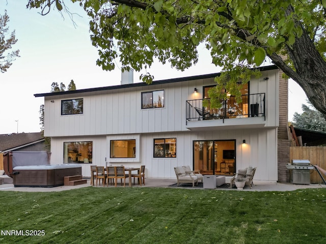 3390 Thornhill Dr, Reno, NV 89509 - back of house with a balcony, a hot tub, a patio, and an outdoor hangout area