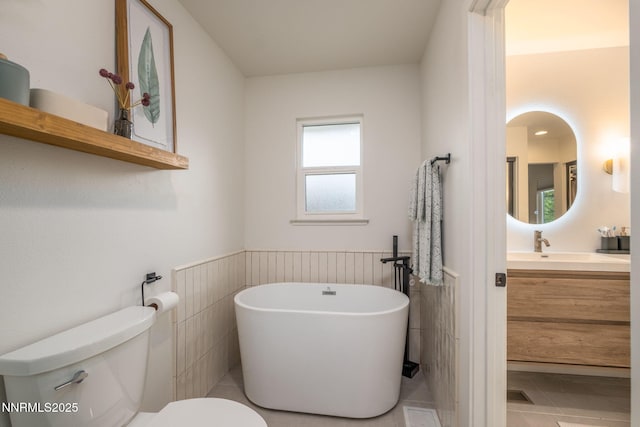 3390 Thornhill Dr, Reno, NV 89509 - bathroom with a freestanding tub, vanity, a wainscoted wall, and tile patterned floors