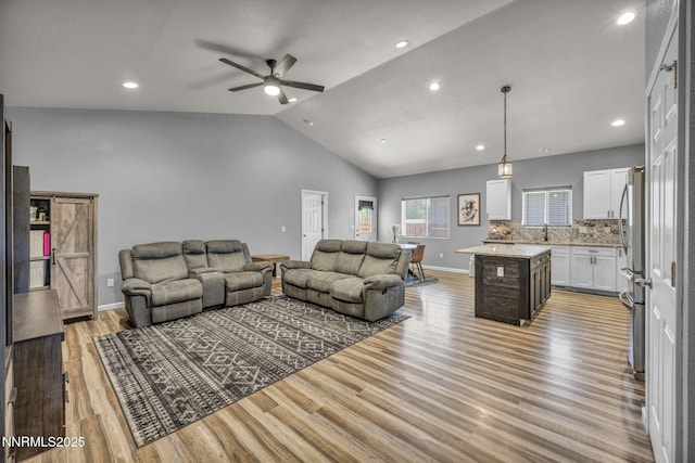 776 Great Basin Ln, Fallon, NV 89406 - living room featuring light wood-style flooring, lofted ceiling, ceiling fan, and recessed lighting