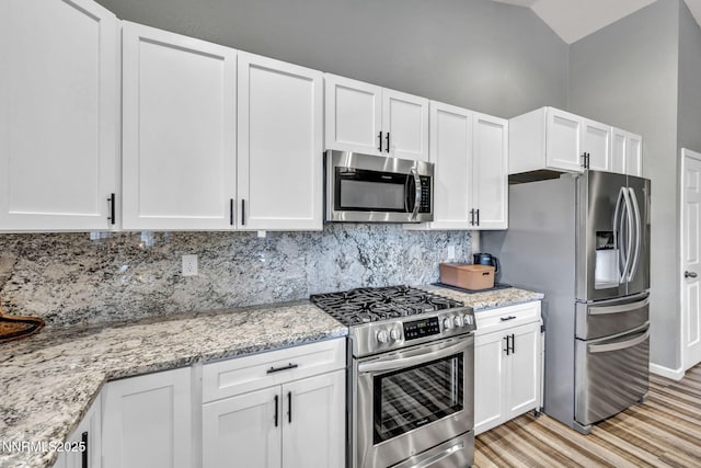 776 Great Basin Ln, Fallon, NV 89406 - kitchen with stainless steel appliances, light wood finished floors, tasteful backsplash, white cabinetry, and light stone countertops