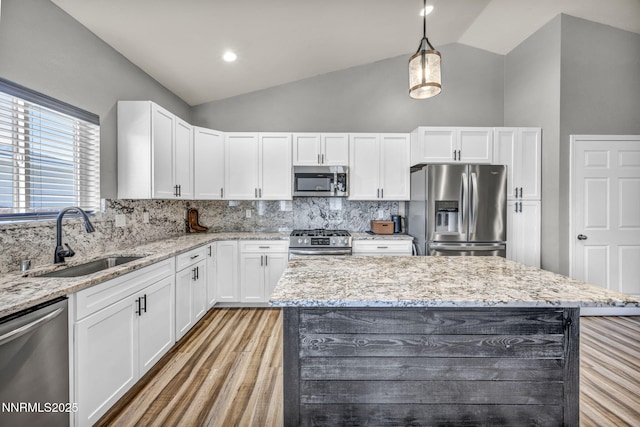 776 Great Basin Ln, Fallon, NV 89406 - kitchen with stainless steel appliances, backsplash, white cabinets, light stone countertops, and high vaulted ceiling