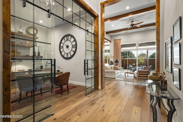 6122 S Pleasant Oak Trl, Reno, NV 89511 - interior space with a barn door, hardwood / wood-style floors, beamed ceiling, ceiling fan, and a towering ceiling