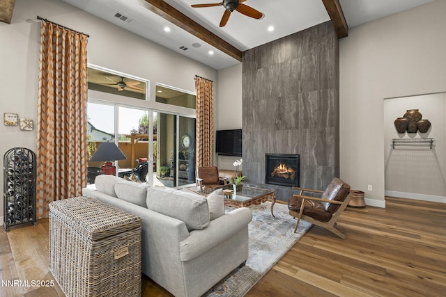 6122 S Pleasant Oak Trl, Reno, NV 89511 - living area featuring a ceiling fan, a high ceiling, beamed ceiling, recessed lighting, and wood finished floors