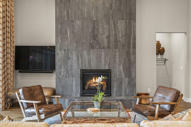 6122 S Pleasant Oak Trl, Reno, NV 89511 - living room featuring a tiled fireplace and wood finished floors