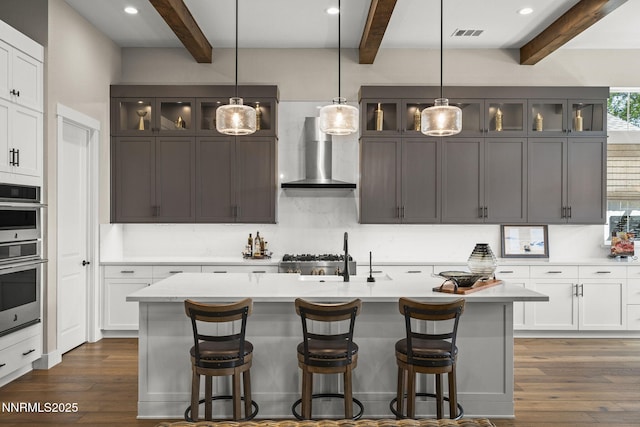 6122 S Pleasant Oak Trl, Reno, NV 89511 - kitchen featuring wall chimney exhaust hood, beam ceiling, light countertops, dark wood-style flooring, and recessed lighting