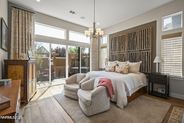 6122 S Pleasant Oak Trl, Reno, NV 89511 - bedroom featuring wood finished floors, a chandelier, recessed lighting, and access to outside