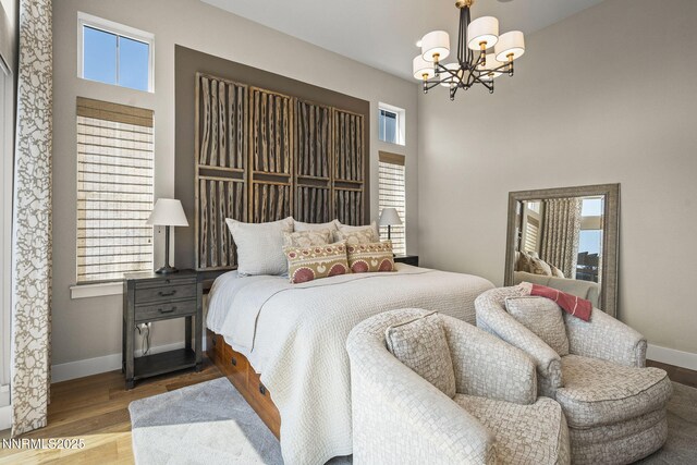 6122 S Pleasant Oak Trl, Reno, NV 89511 - bedroom featuring a chandelier and wood finished floors