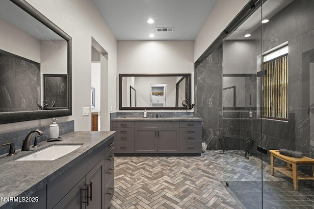 6122 S Pleasant Oak Trl, Reno, NV 89511 - bathroom featuring walk in shower, two vanities, tile walls, and recessed lighting