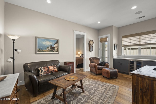 6122 S Pleasant Oak Trl, Reno, NV 89511 - living area featuring wine cooler, bar, wood finished floors, and recessed lighting