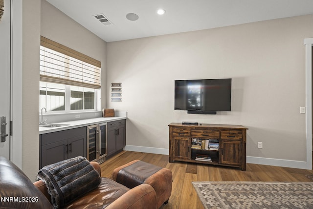 6122 S Pleasant Oak Trl, Reno, NV 89511 - living room with beverage cooler, light wood-style floors, recessed lighting, and bar