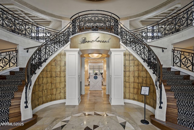 6122 S Pleasant Oak Trl, Reno, NV 89511 - foyer with inlaid floor details, ornate columns, a high ceiling, stairway, and arched walkways
