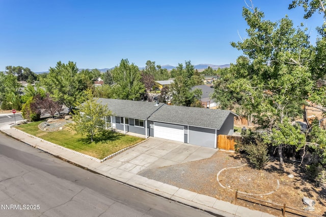 1419 Leonard Rd, Gardnerville, NV 89460 - view of front of home featuring concrete driveway, an attached garage, a mountain view, and roof with shingles