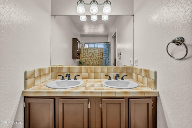 1419 Leonard Rd, Gardnerville, NV 89460 - full bath with a textured wall, double vanity, and a textured ceiling