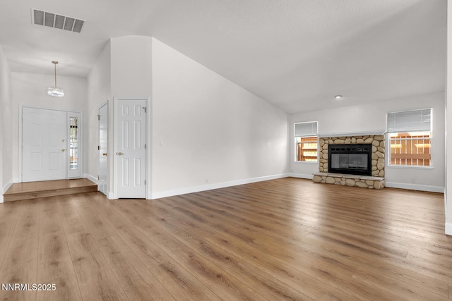 2240 Silver Ridge Dr, Reno, NV 89509 - unfurnished living room with light wood-type flooring and a stone fireplace