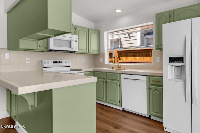 2240 Silver Ridge Dr, Reno, NV 89509 - kitchen featuring white appliances, recessed lighting, tasteful backsplash, tile countertops, and green cabinetry