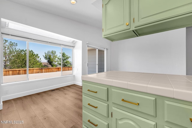 2240 Silver Ridge Dr, Reno, NV 89509 - kitchen with tile countertops, light wood finished floors, green cabinetry, and recessed lighting