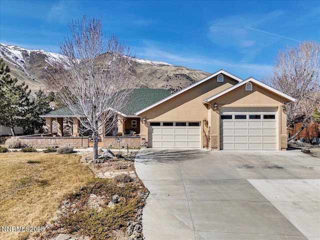 1962 Comstock Dr, Gardnerville, NV 89410 - ranch-style home featuring stucco siding, a mountain view, a garage, driveway, and a front lawn