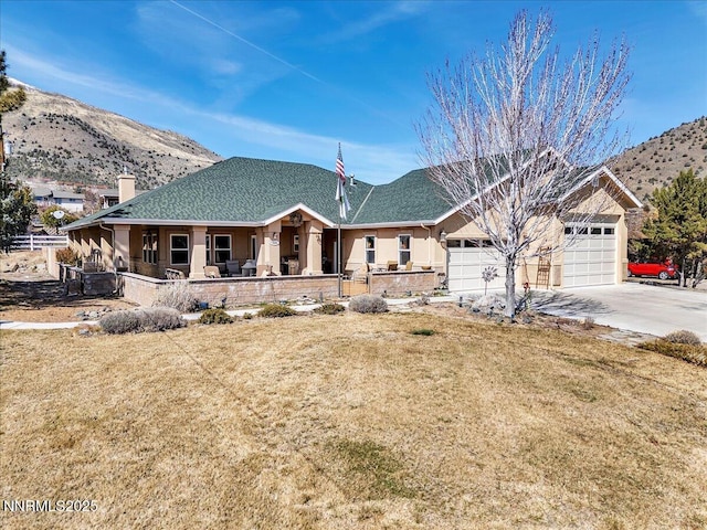 1962 Comstock Dr, Gardnerville, NV 89410 - view of front of house with covered porch, a mountain view, a front yard, and concrete driveway