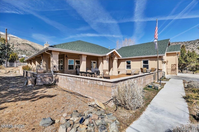 1962 Comstock Dr, Gardnerville, NV 89410 - back of property featuring stucco siding, a patio, roof with shingles, and a mountain view