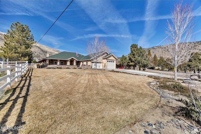 1962 Comstock Dr, Gardnerville, NV 89410 - view of front of house featuring a garage, a mountain view, and driveway
