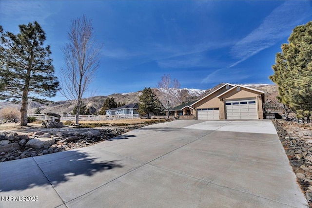 1962 Comstock Dr, Gardnerville, NV 89410 - view of front of home with a garage, a mountain view, and driveway