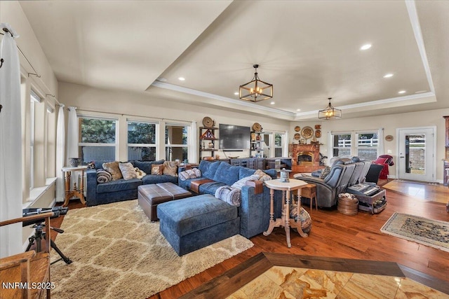 1962 Comstock Dr, Gardnerville, NV 89410 - living area with a raised ceiling, recessed lighting, a chandelier, wood finished floors, and ornamental molding