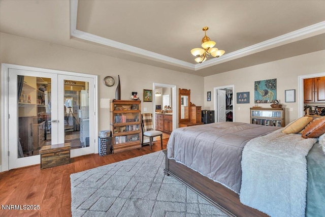 1962 Comstock Dr, Gardnerville, NV 89410 - bedroom featuring a raised ceiling, french doors, a walk in closet, a chandelier, and crown molding