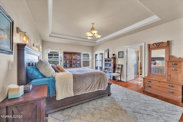 1962 Comstock Dr, Gardnerville, NV 89410 - bedroom featuring a tray ceiling, a chandelier, wood finished floors, and ornamental molding