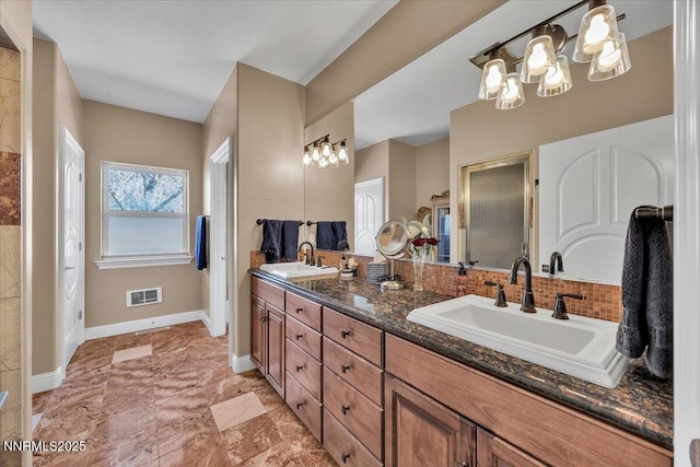 1962 Comstock Dr, Gardnerville, NV 89410 - full bathroom featuring a chandelier, double vanity, and backsplash