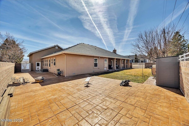 1962 Comstock Dr, Gardnerville, NV 89410 - rear view of property with a gate, a fenced backyard, a patio area, and stucco siding