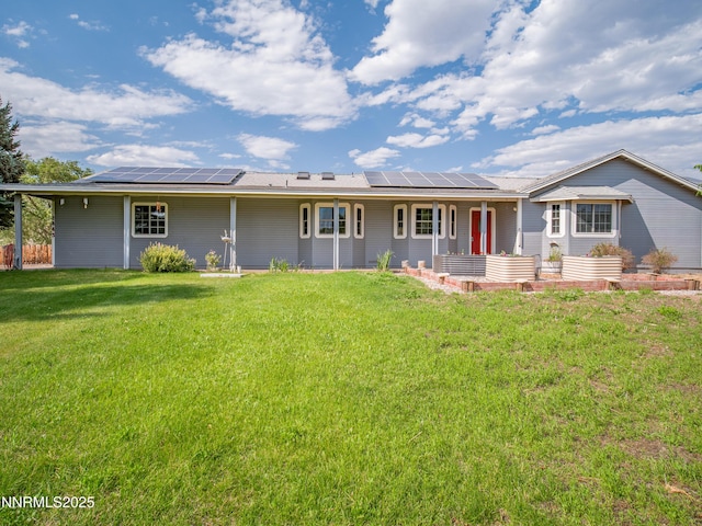 2843 Wade St, Minden, NV 89423 - back of property featuring solar panels, covered porch, and a lawn