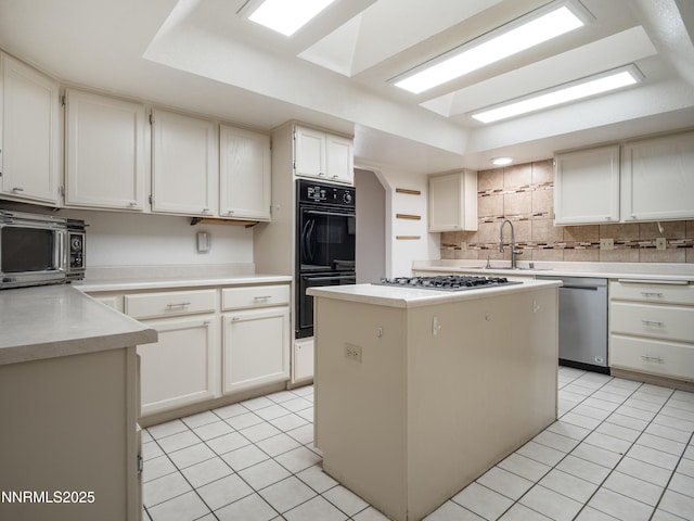 2843 Wade St, Minden, NV 89423 - kitchen with stainless steel appliances, light tile patterned floors, a raised ceiling, and tasteful backsplash
