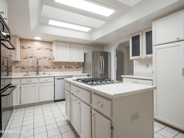 2843 Wade St, Minden, NV 89423 - kitchen with appliances with stainless steel finishes, light tile patterned floors, a kitchen island, backsplash, and light countertops