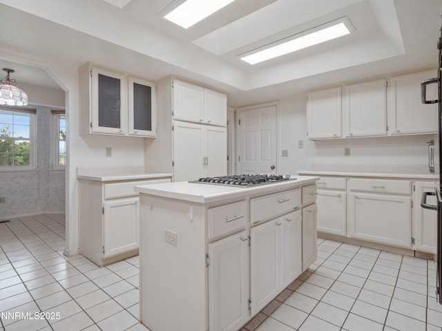 2843 Wade St, Minden, NV 89423 - kitchen featuring stainless steel gas stovetop, light tile patterned flooring, a kitchen island, and light countertops
