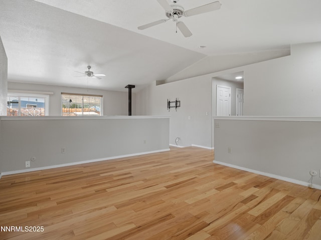 2843 Wade St, Minden, NV 89423 - spare room featuring a ceiling fan, wood finished floors, lofted ceiling, and a wood stove