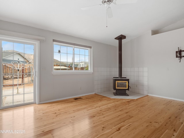 2843 Wade St, Minden, NV 89423 - unfurnished living room with wood finished floors, a wood stove, and a ceiling fan