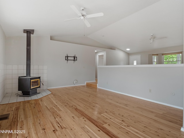 2843 Wade St, Minden, NV 89423 - unfurnished living room featuring a ceiling fan, lofted ceiling, a wood stove, and light wood finished floors