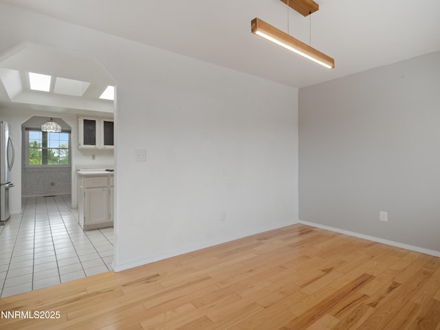 2843 Wade St, Minden, NV 89423 - empty room featuring a skylight and light wood-style flooring