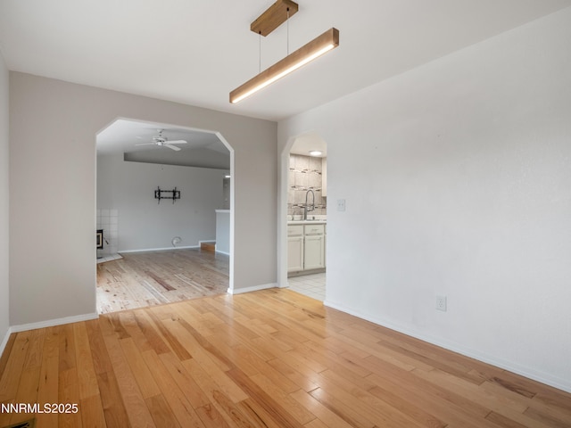 2843 Wade St, Minden, NV 89423 - unfurnished room featuring arched walkways, light wood-style floors, and a ceiling fan