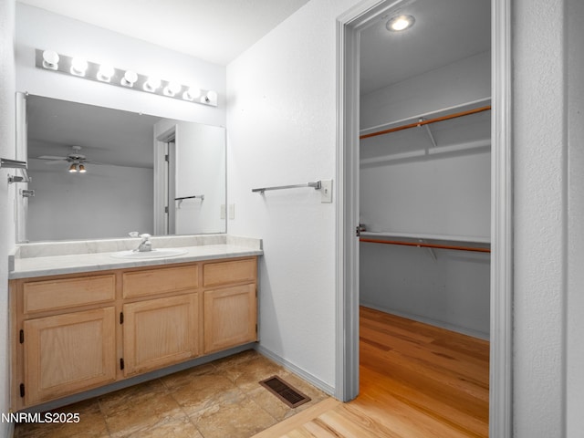 2843 Wade St, Minden, NV 89423 - bathroom with vanity, a spacious closet, and ceiling fan