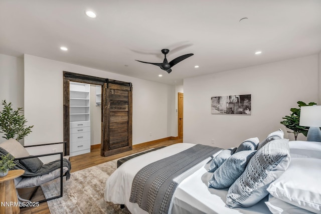 116 Cypress Way, Stateline, NV 89449 - bedroom featuring a barn door, wood finished floors, recessed lighting, a spacious closet, and ceiling fan