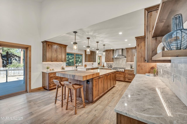 116 Cypress Way, Stateline, NV 89449 - kitchen featuring wall chimney range hood, a spacious island, backsplash, brown cabinetry, and recessed lighting