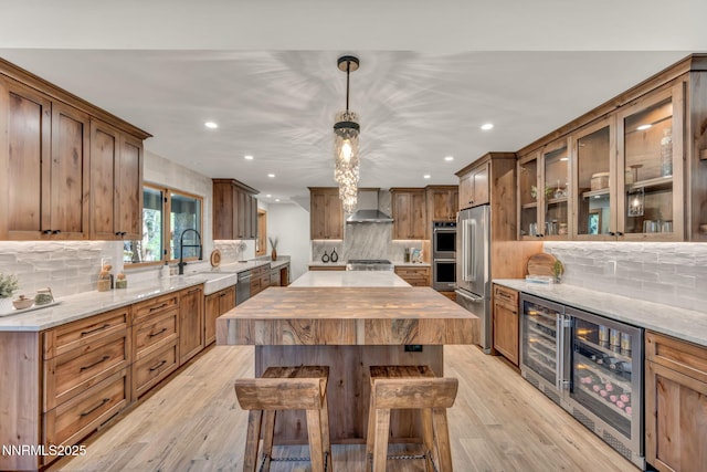 116 Cypress Way, Stateline, NV 89449 - kitchen with appliances with stainless steel finishes, beverage cooler, wall chimney range hood, recessed lighting, and decorative backsplash