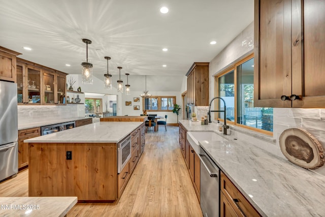 116 Cypress Way, Stateline, NV 89449 - kitchen with appliances with stainless steel finishes, recessed lighting, tasteful backsplash, light wood-type flooring, and a center island