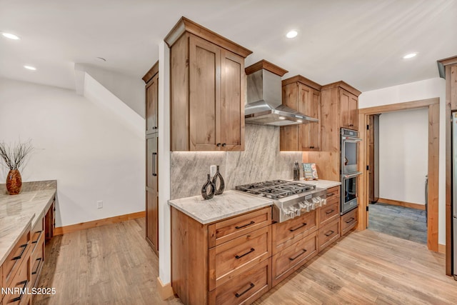 116 Cypress Way, Stateline, NV 89449 - kitchen with appliances with stainless steel finishes, wall chimney exhaust hood, backsplash, light wood-style floors, and recessed lighting