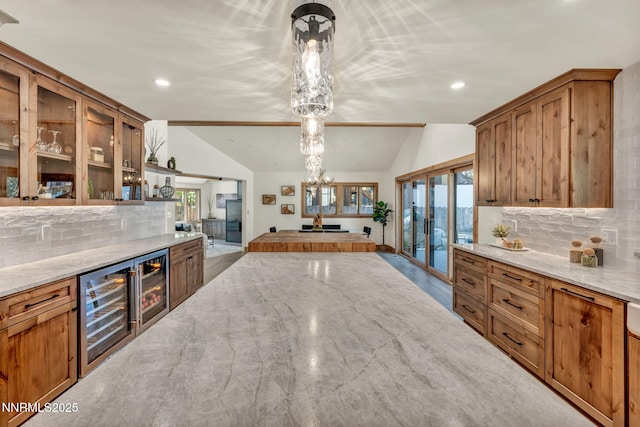 116 Cypress Way, Stateline, NV 89449 - kitchen featuring vaulted ceiling, beverage cooler, brown cabinetry, decorative backsplash, and recessed lighting