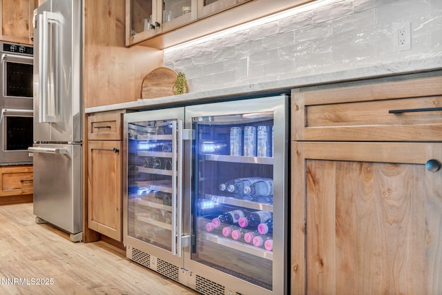 116 Cypress Way, Stateline, NV 89449 - bar with wine cooler, appliances with stainless steel finishes, light wood-style flooring, and backsplash